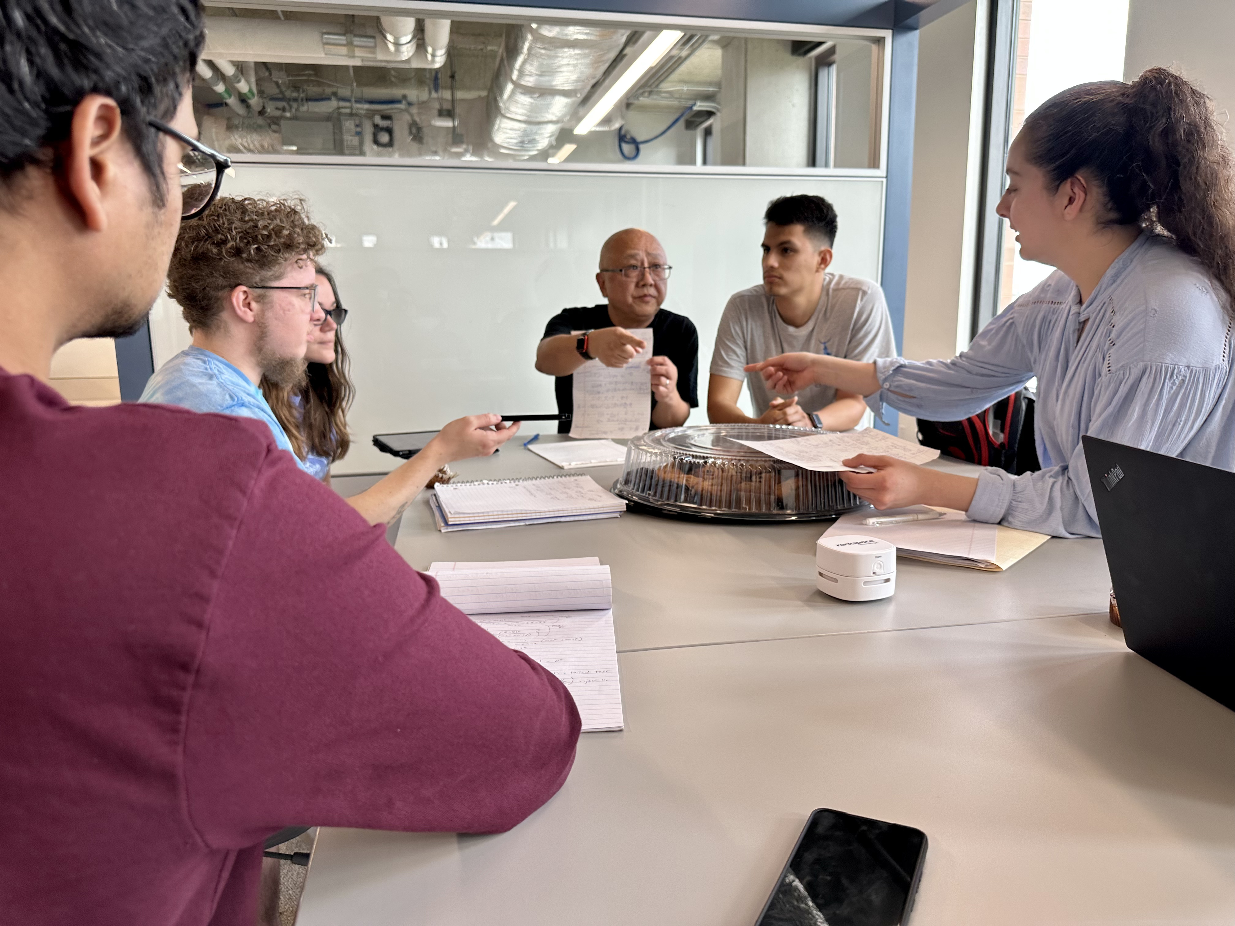 Professor at a table with students