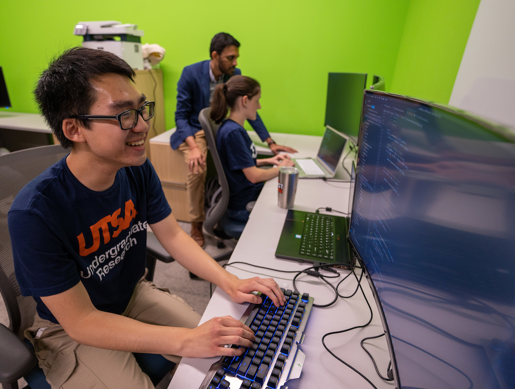 Student typing on a computer in a lab